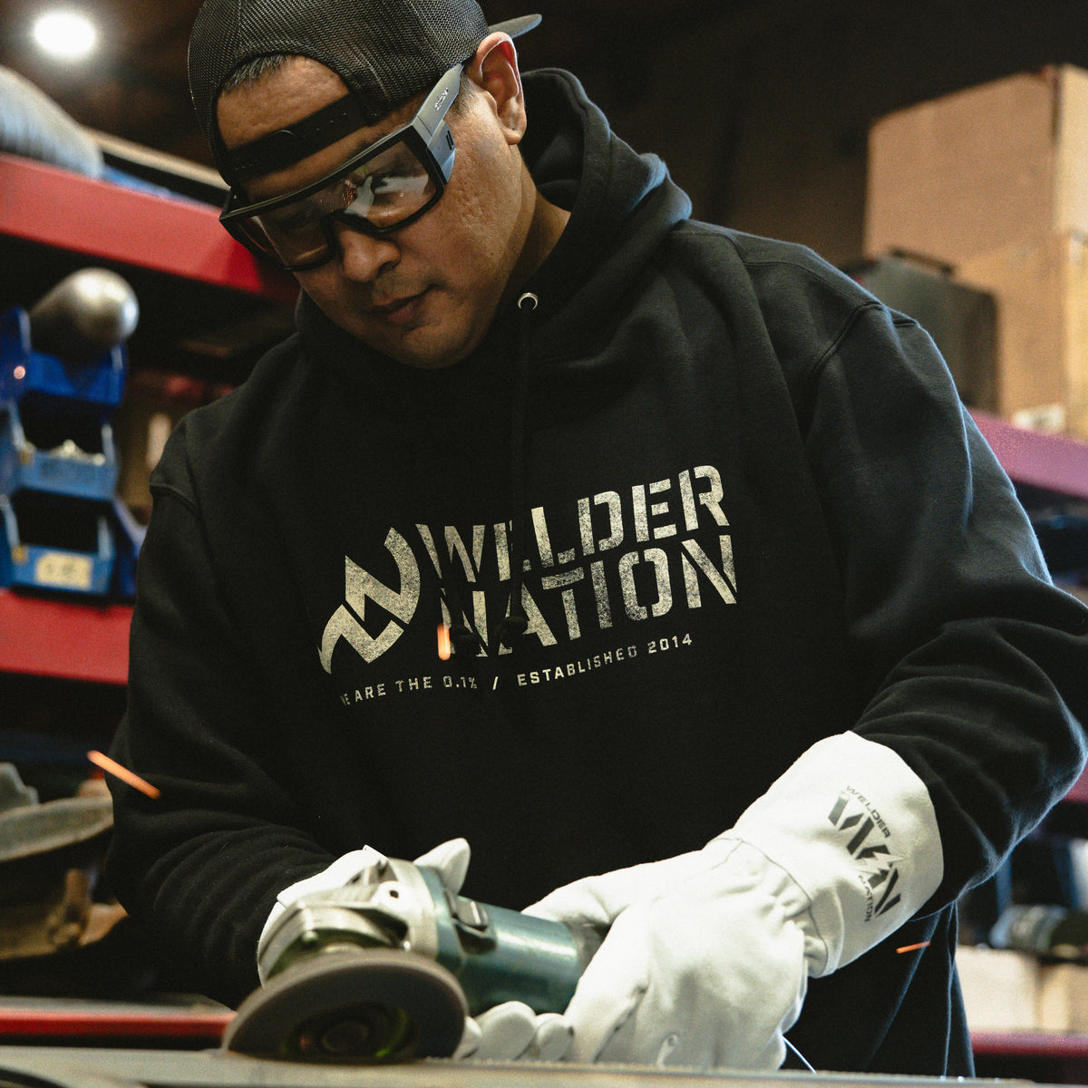 Person wearing Welder Nation Stick Welding Gloves and Welder Nation black hoodie